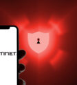 Fortinet logo on a smartphone in front of a defense shield as a symbolic image for antivirus software, anti spam, scam, malware Fortinet logo on a smartphone in front of a defense shield as a symbolic image for antivirus software, anti spam, scam, malware